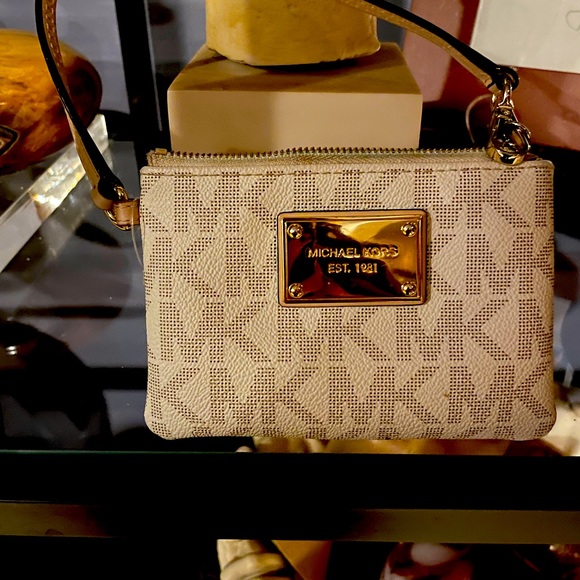 Michael Kors Handbags - Michael Kors medium logo wristlet. New no tags been in my closet.